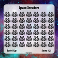 Sheet of Space Invaders stickers with a space-themed background